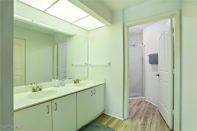 800 New Waterford Dr Unit A202, Naples, FL 34104 - bathroom with wood finished floors, a shower stall, and double vanity