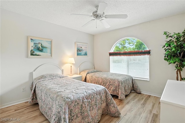 800 New Waterford Dr Unit A202, Naples, FL 34104 - bedroom featuring light wood-style flooring, a textured ceiling, and ceiling fan