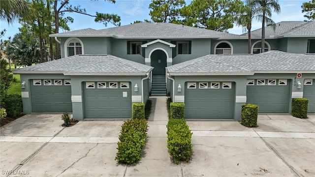 800 New Waterford Dr Unit A202, Naples, FL 34104 - view of front of home featuring stucco siding, a garage, and a shingled roof