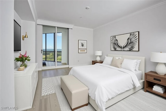24011 Via Castella Dr Unit 2402, Bonita Springs, FL 34134 - bedroom featuring access to exterior, crown molding, and light wood-type flooring