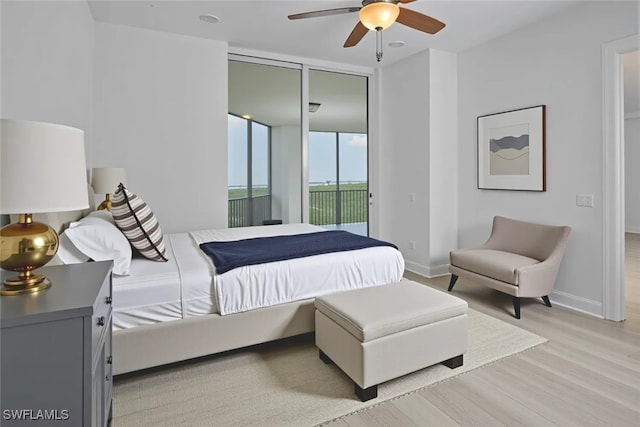 24011 Via Castella Dr Unit 2402, Bonita Springs, FL 34134 - bedroom featuring light wood-type flooring, access to outside, and ceiling fan