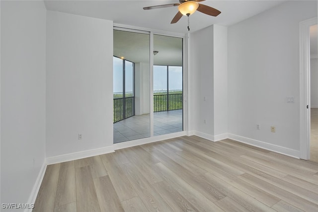 24011 Via Castella Dr Unit 2402, Bonita Springs, FL 34134 - unfurnished room with expansive windows, a ceiling fan, and wood finished floors