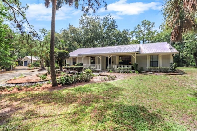 3110 10th Ave SE, Naples, FL 34117 - single story home featuring covered porch, a metal roof, and a front yard
