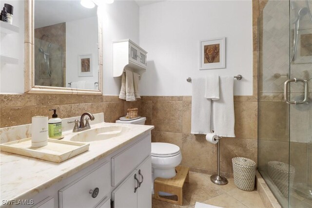 3110 10th Ave SE, Naples, FL 34117 - full bath featuring vanity, a shower stall, tile walls, a wainscoted wall, and tile patterned flooring