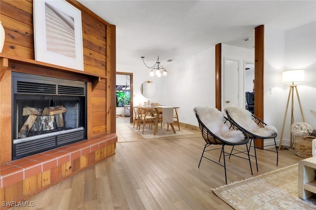 3110 10th Ave SE, Naples, FL 34117 - living room featuring a tile fireplace, wood finished floors, and a chandelier