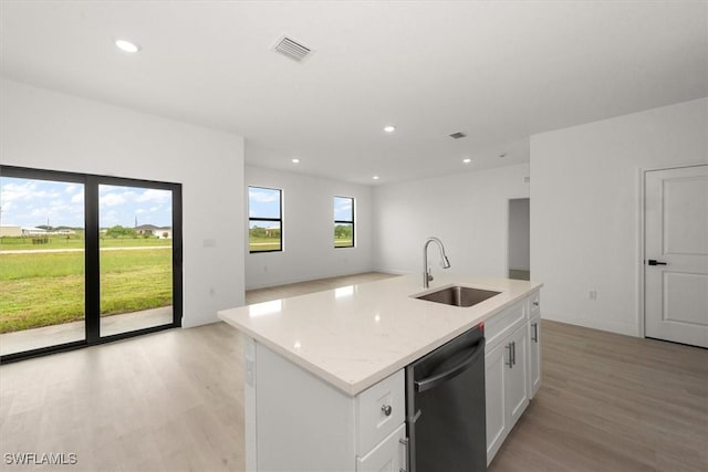 9013 Largo Cir, Labelle, FL 33935 - kitchen with dishwasher, light wood-style flooring, white cabinets, recessed lighting, and open floor plan