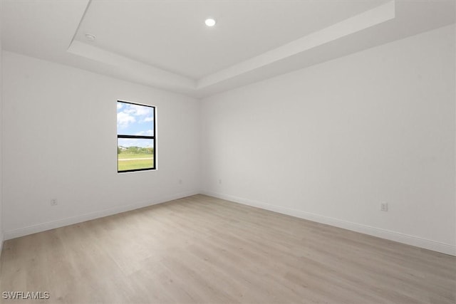 9013 Largo Cir, Labelle, FL 33935 - unfurnished room with a raised ceiling, light wood finished floors, and recessed lighting
