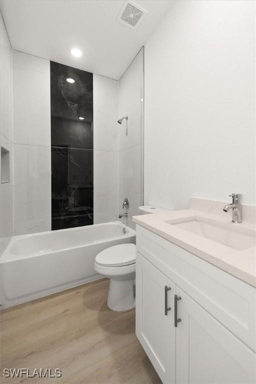 9013 Largo Cir, Labelle, FL 33935 - bathroom featuring vanity, wood finished floors,  shower combination, and recessed lighting