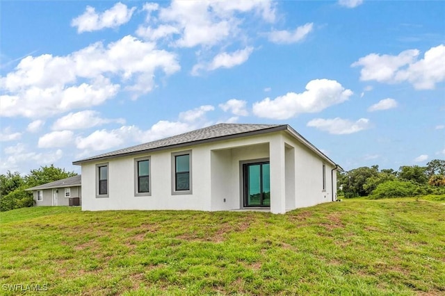 9013 Largo Cir, Labelle, FL 33935 - rear view of house with stucco siding and a yard