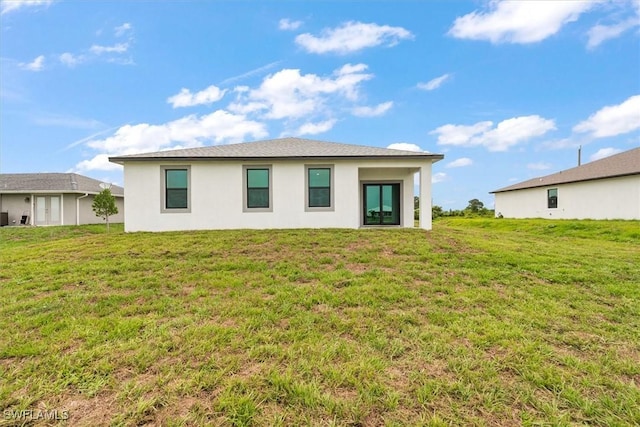 9013 Largo Cir, Labelle, FL 33935 - back of house featuring stucco siding and a yard