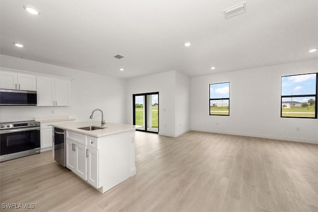 9013 Largo Cir, Labelle, FL 33935 - kitchen featuring appliances with stainless steel finishes, open floor plan, healthy amount of natural light, light wood-type flooring, and recessed lighting