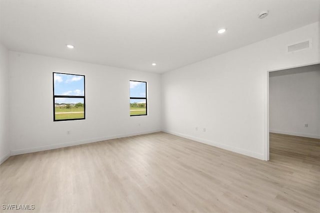 9013 Largo Cir, Labelle, FL 33935 - empty room featuring light wood-type flooring, a smoke detector, and recessed lighting
