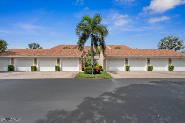 2370 Magnolia Ave Unit 6807, Naples, FL 34112 - view of front of house with community garages, a tile roof, and stucco siding