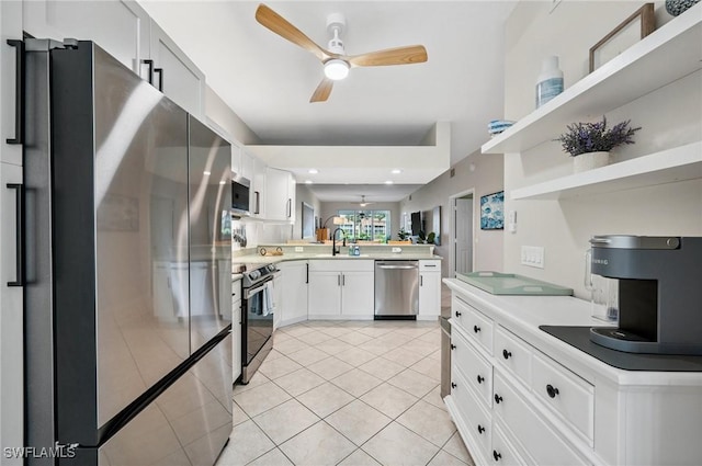 2370 Magnolia Ave Unit 6807, Naples, FL 34112 - kitchen with a ceiling fan, stainless steel appliances, a peninsula, light tile patterned flooring, and white cabinets