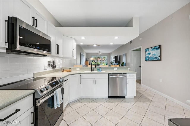 2370 Magnolia Ave Unit 6807, Naples, FL 34112 - kitchen with appliances with stainless steel finishes, a peninsula, backsplash, light countertops, and recessed lighting