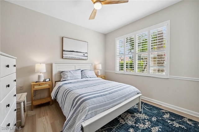 2370 Magnolia Ave Unit 6807, Naples, FL 34112 - bedroom with light wood finished floors and ceiling fan