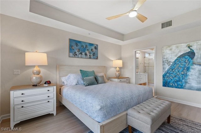 2370 Magnolia Ave Unit 6807, Naples, FL 34112 - bedroom with wood finished floors, ensuite bath, and a ceiling fan
