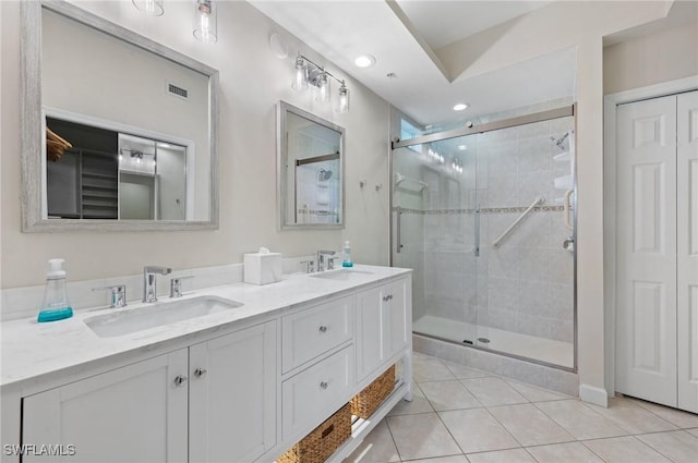 2370 Magnolia Ave Unit 6807, Naples, FL 34112 - full bathroom with double vanity, a shower stall, tile patterned floors, recessed lighting, and a closet