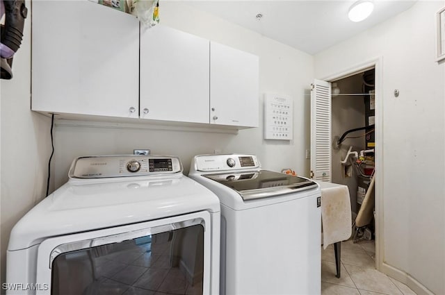2370 Magnolia Ave Unit 6807, Naples, FL 34112 - washroom with independent washer and dryer, cabinet space, and light tile patterned floors