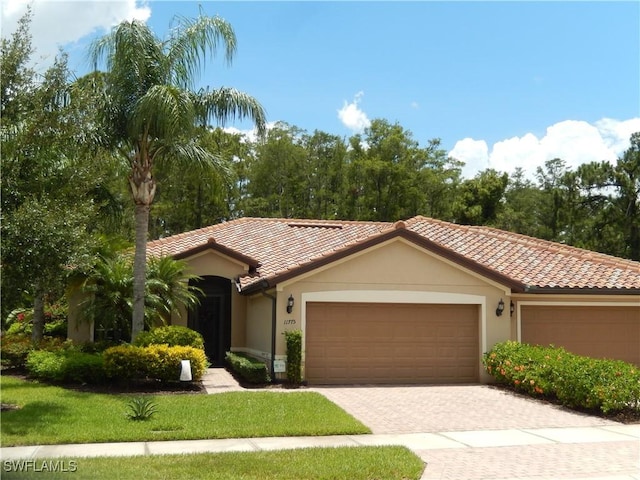 11775 Avingston Ter, Fort Myers, FL 33913 - mediterranean / spanish home featuring an attached garage, stucco siding, driveway, and a tile roof