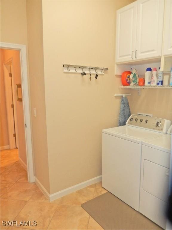 11775 Avingston Ter, Fort Myers, FL 33913 - laundry room with washing machine and dryer, cabinet space, and light tile patterned flooring