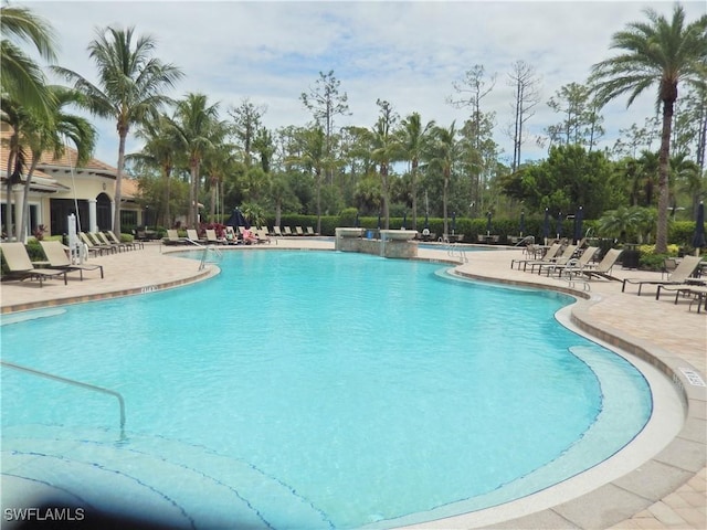 11775 Avingston Ter, Fort Myers, FL 33913 - community pool featuring a patio and view of scattered trees