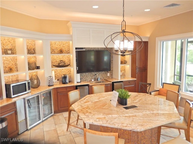 11775 Avingston Ter, Fort Myers, FL 33913 - dining room with a chandelier, crown molding, light tile patterned floors, wine cooler, and recessed lighting