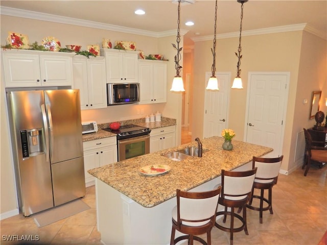 11775 Avingston Ter, Fort Myers, FL 33913 - kitchen featuring appliances with stainless steel finishes, white cabinetry, a center island with sink, a kitchen breakfast bar, and ornamental molding