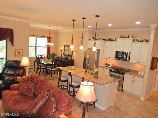 11775 Avingston Ter, Fort Myers, FL 33913 - kitchen featuring appliances with stainless steel finishes, a kitchen bar, white cabinetry, a kitchen island with sink, and crown molding