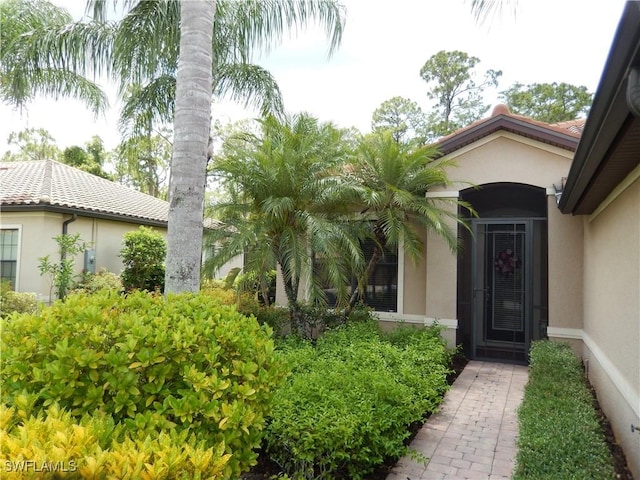 11775 Avingston Ter, Fort Myers, FL 33913 - doorway to property featuring stucco siding