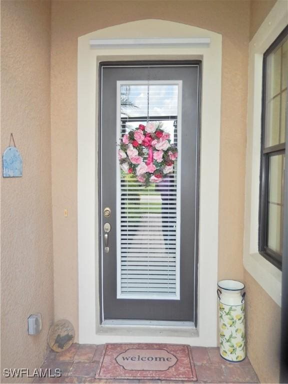 11775 Avingston Ter, Fort Myers, FL 33913 - doorway to property featuring stucco siding
