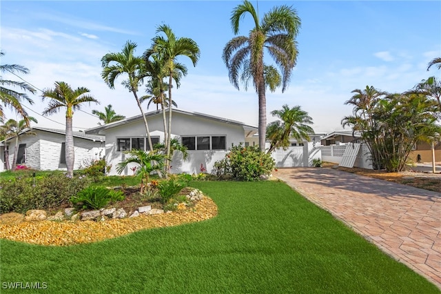 465 Donora Blvd, Fort Myers Beach, FL 33931 - view of front of house featuring driveway, stucco siding, and a garage