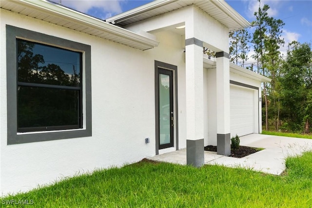 2803 E 13th St, Lehigh Acres, FL 33972 - entrance to property with stucco siding and a garage