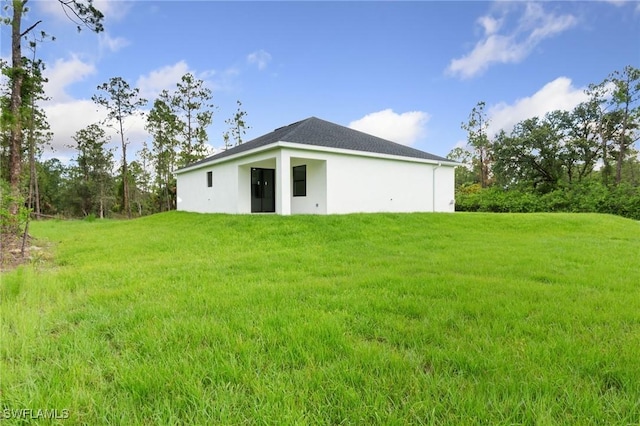 2803 E 13th St, Lehigh Acres, FL 33972 - back of property with a yard and stucco siding