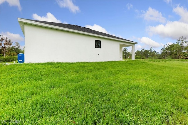 2803 E 13th St, Lehigh Acres, FL 33972 - view of home's exterior featuring stucco siding and a yard