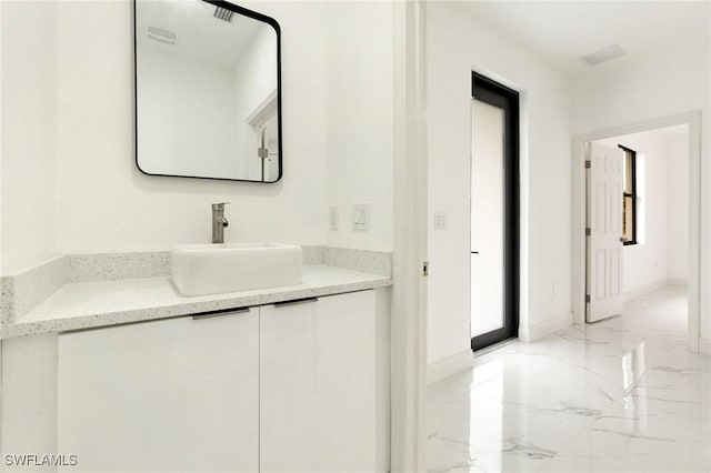2803 E 13th St, Lehigh Acres, FL 33972 - bathroom featuring marble tiled floors and vanity