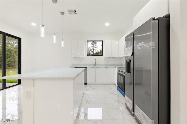 2803 E 13th St, Lehigh Acres, FL 33972 - kitchen with appliances with stainless steel finishes, modern cabinets, light marble finish floors, and recessed lighting