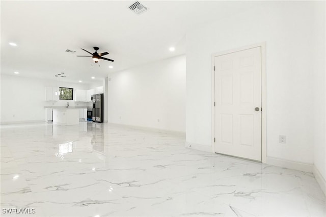 2803 E 13th St, Lehigh Acres, FL 33972 - unfurnished living room with ceiling fan, recessed lighting, and light marble finish floors