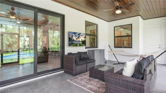 1030 22nd Ave NE, Naples, FL 34120 - view of patio with ceiling fan, an outdoor living space, and an outdoor pool