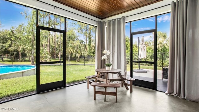 1030 22nd Ave NE, Naples, FL 34120 - sunroom / solarium featuring view of scattered trees
