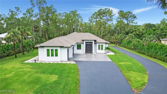 1030 22nd Ave NE, Naples, FL 34120 - view of front of home featuring asphalt driveway, stucco siding, and a front yard
