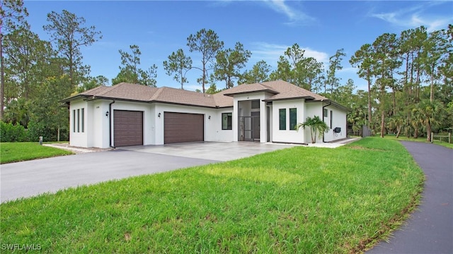 1030 22nd Ave NE, Naples, FL 34120 - prairie-style house with an attached garage, driveway, stucco siding, and a front yard