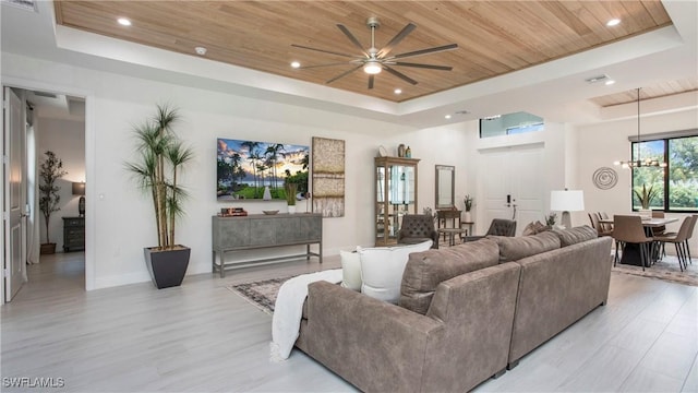 1030 22nd Ave NE, Naples, FL 34120 - living area featuring a tray ceiling, wooden ceiling, a ceiling fan, light wood-style flooring, and a chandelier