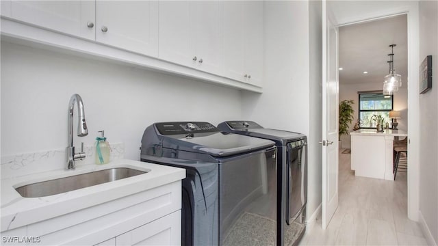 1030 22nd Ave NE, Naples, FL 34120 - laundry area featuring cabinet space and independent washer and dryer