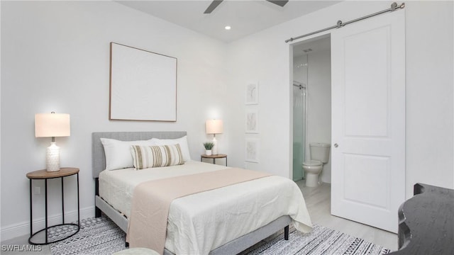 1030 22nd Ave NE, Naples, FL 34120 - bedroom featuring ensuite bath, recessed lighting, a ceiling fan, and a barn door