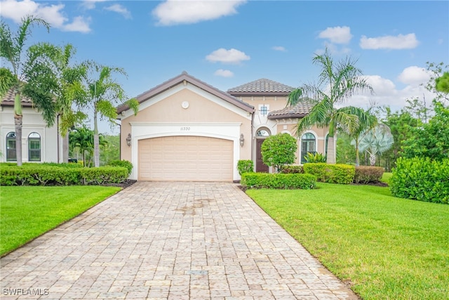 11330 Hidalgo Ct, Fort Myers, FL 33912 - mediterranean / spanish house featuring decorative driveway, an attached garage, stucco siding, a front yard, and a tile roof