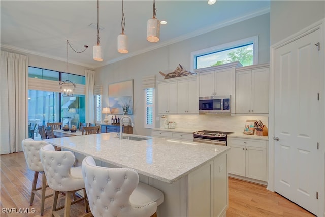 11330 Hidalgo Ct, Fort Myers, FL 33912 - kitchen featuring stainless steel appliances, ornamental molding, plenty of natural light, white cabinets, and recessed lighting