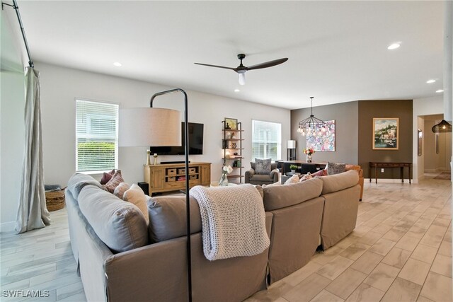 3387 Pilot Cir, Naples, FL 34120 - living room featuring a ceiling fan, recessed lighting, light wood finished floors, and a chandelier