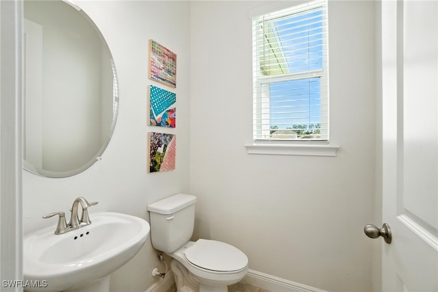 3387 Pilot Cir, Naples, FL 34120 - half bathroom featuring a sink and baseboards