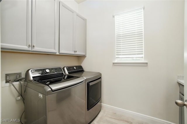 3387 Pilot Cir, Naples, FL 34120 - washroom featuring washing machine and dryer and cabinet space
